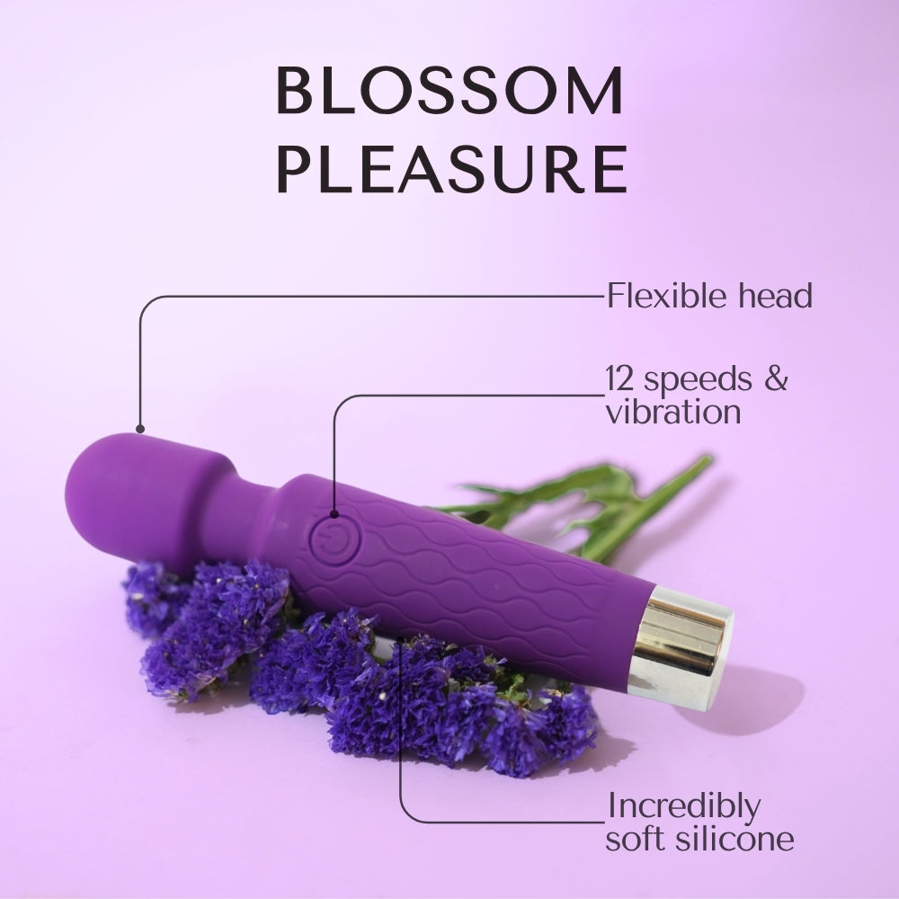 Purple handheld massager, showcasing premium wellness with floral elements on a pink background.